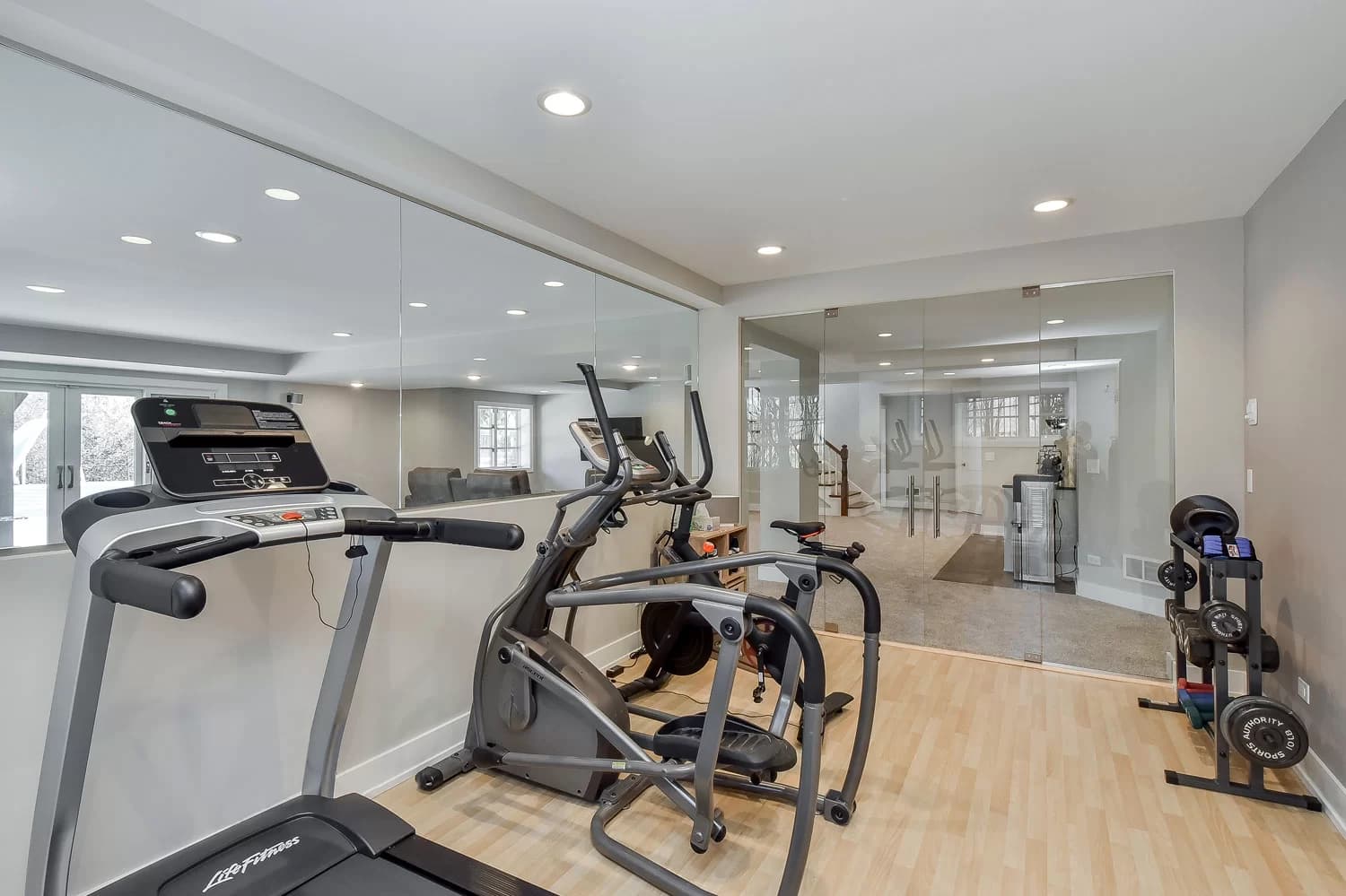 Basement wet bar with custom cabinetry and stone countertops
