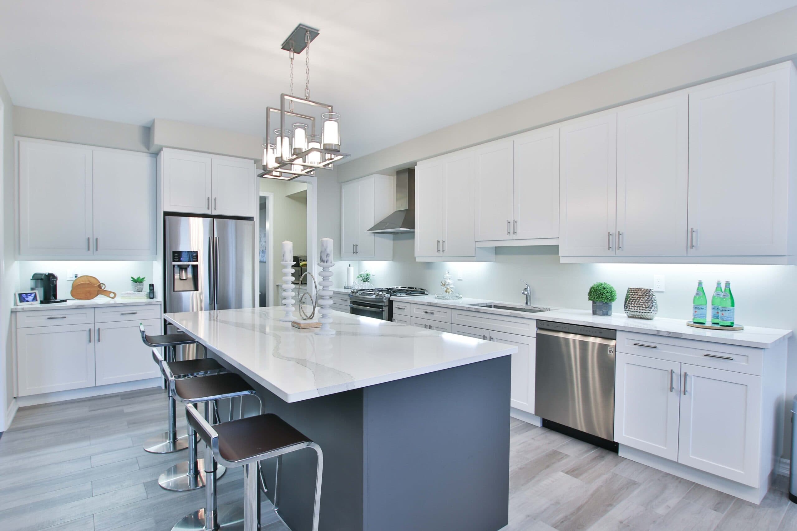 Modern kitchen with island and under-cabinet lighting by Giant Builders Seattle